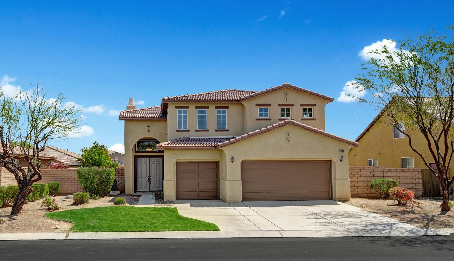 37348 Blackburn Road Indio, CA 92203 - Photo 1 of 30 a front view of a house with a yard and garage