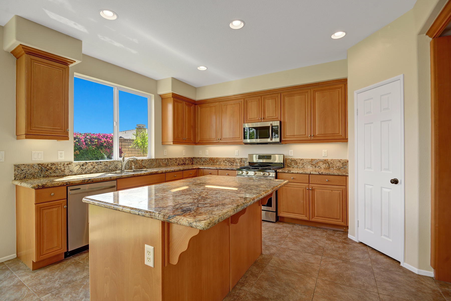 37348 Blackburn Road Indio, CA 92203 - Photo 8 of 30 a kitchen with stainless steel appliances granite countertop a stove a sink a refrigerator a microwave and cabinets