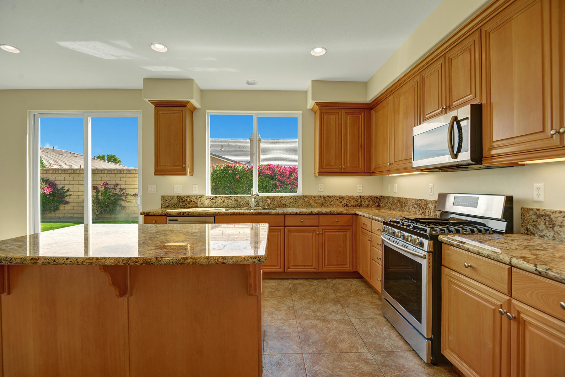 37348 Blackburn Road Indio, CA 92203 - Photo 9 of 30 a kitchen with stainless steel appliances granite countertop a stove a sink and a microwave