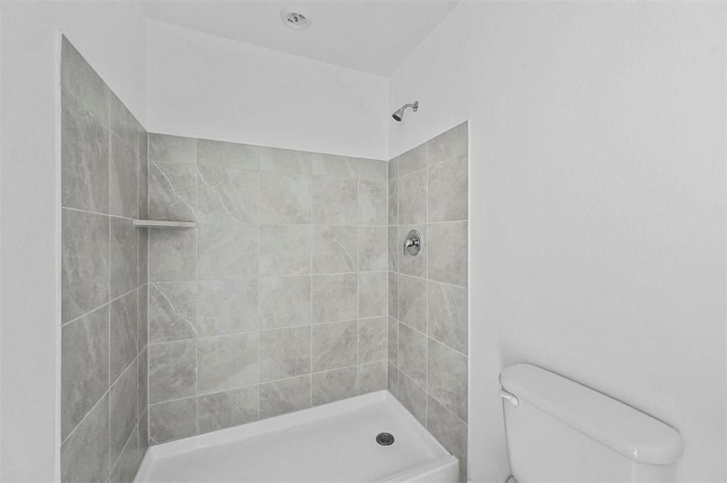 1737 Overall Lane Dallas, TX 75253 - Photo 18 of 21 a bathroom with a shower and toilet