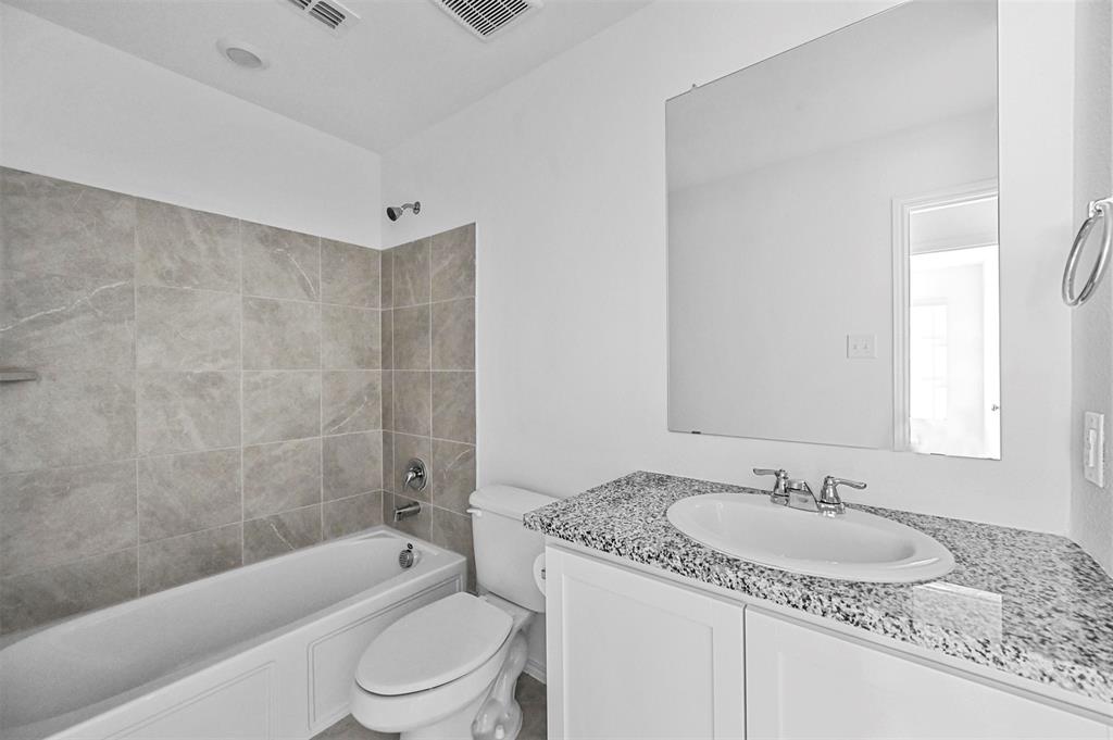 1737 Overall Lane Dallas, TX 75253 - Photo 4 of 21 a bathroom with a granite countertop sink toilet tub and shower