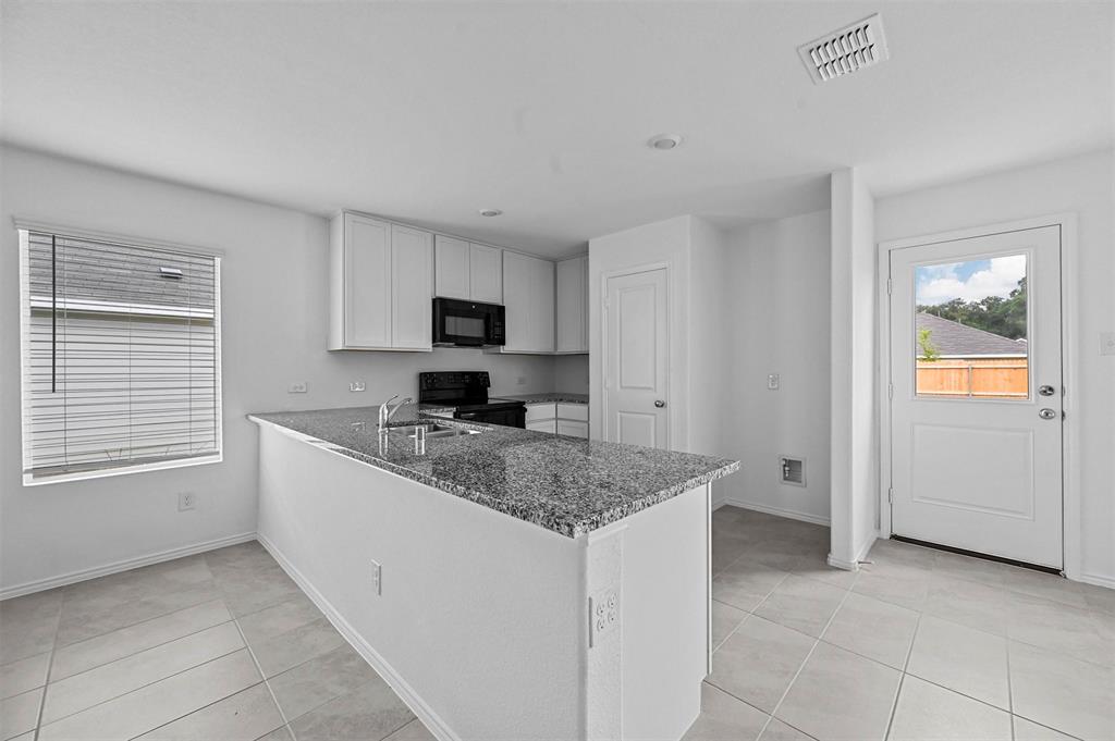 1737 Overall Lane Dallas, TX 75253 - Photo 10 of 21 a kitchen with stainless steel appliances granite countertop a sink stove and cabinets