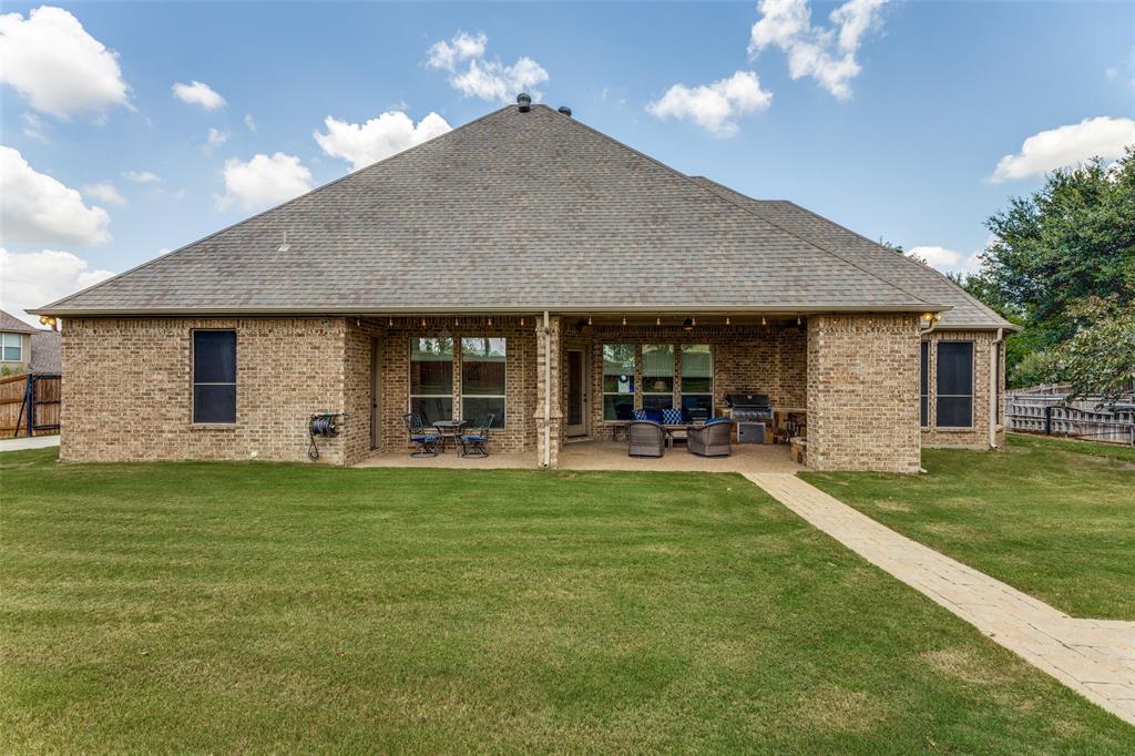 229 Arbor Lane Haslet, TX 76052 - Photo 25 of 34 Expansive backyard featuring a brick exterior and a covered patio