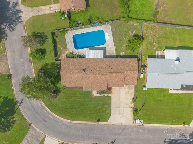 an aerial view of a house with outdoor space and a lake view
