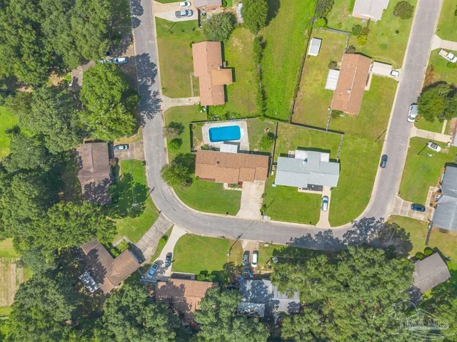 an aerial view of a house with outdoor space