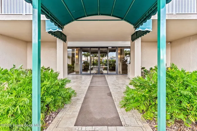 a view of a pathway with a flower garden