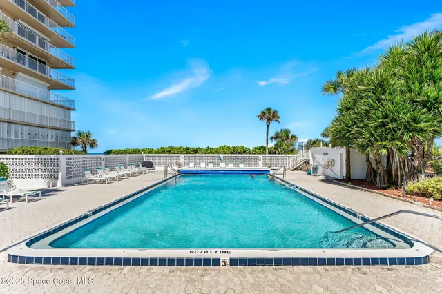 a view of a swimming pool with an outdoor seating