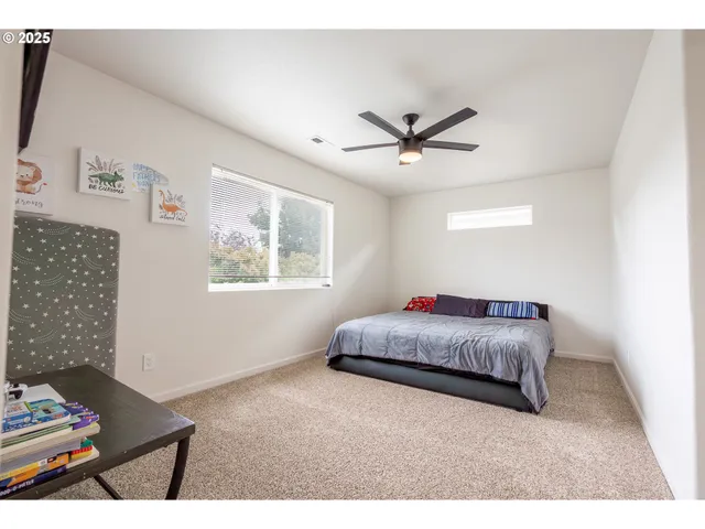 a bedroom with a large bed and a flat screen tv