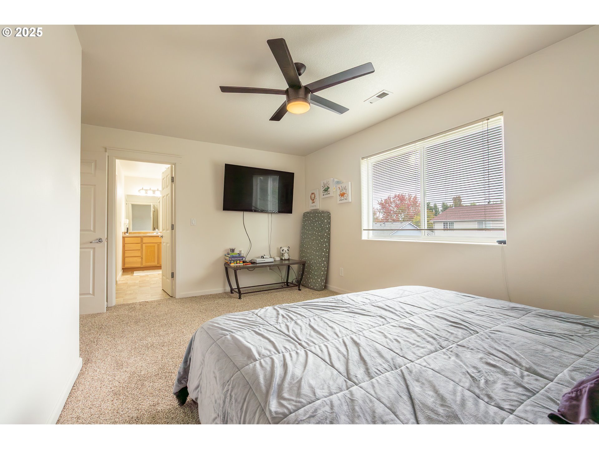 621 Jasmine Circle Independence, OR 97351 - Photo 17 of 29 a bedroom with a large bed and a flat screen tv