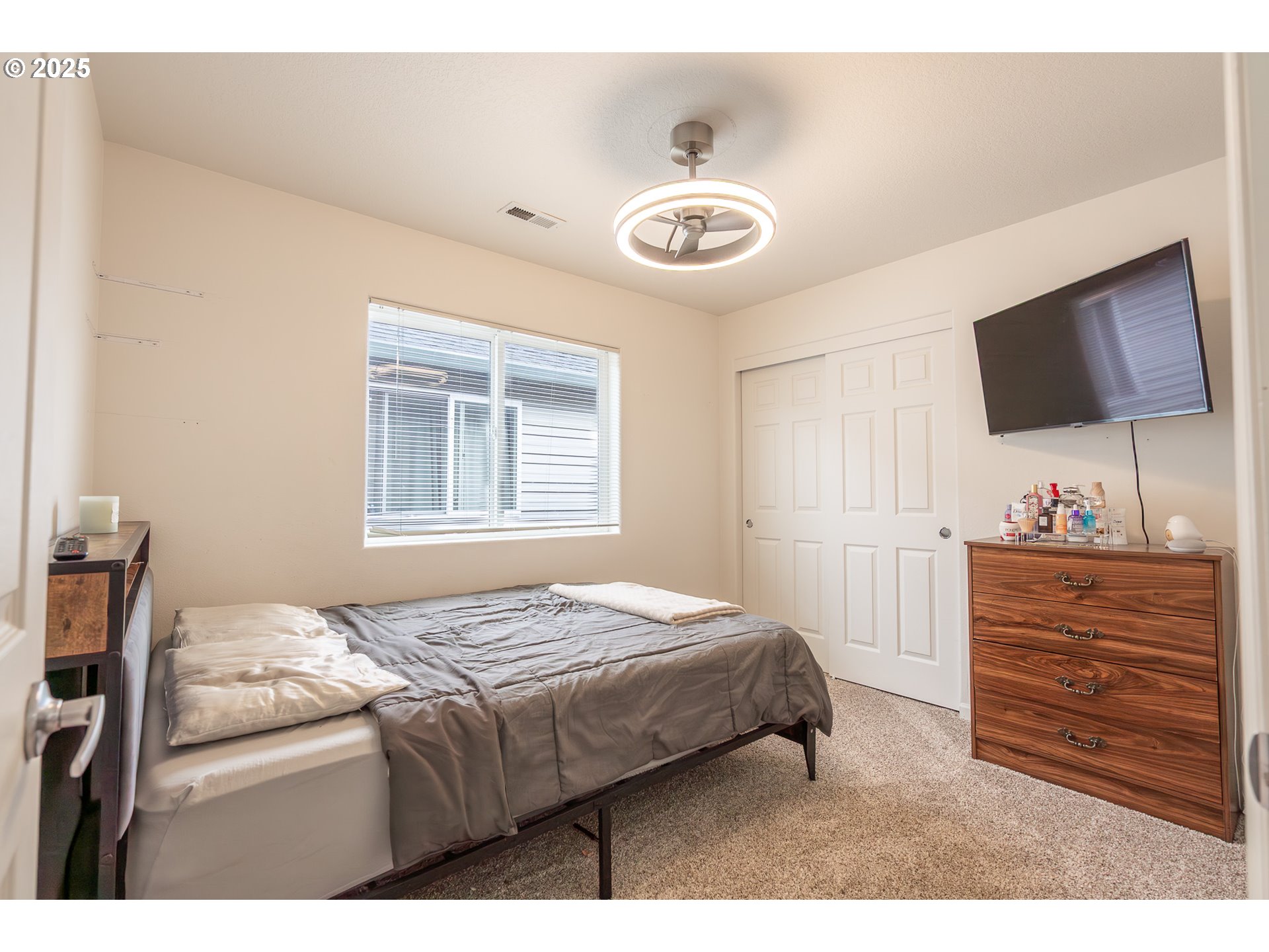 621 Jasmine Circle Independence, OR 97351 - Photo 21 of 29 a bedroom with a bed and a flat screen tv