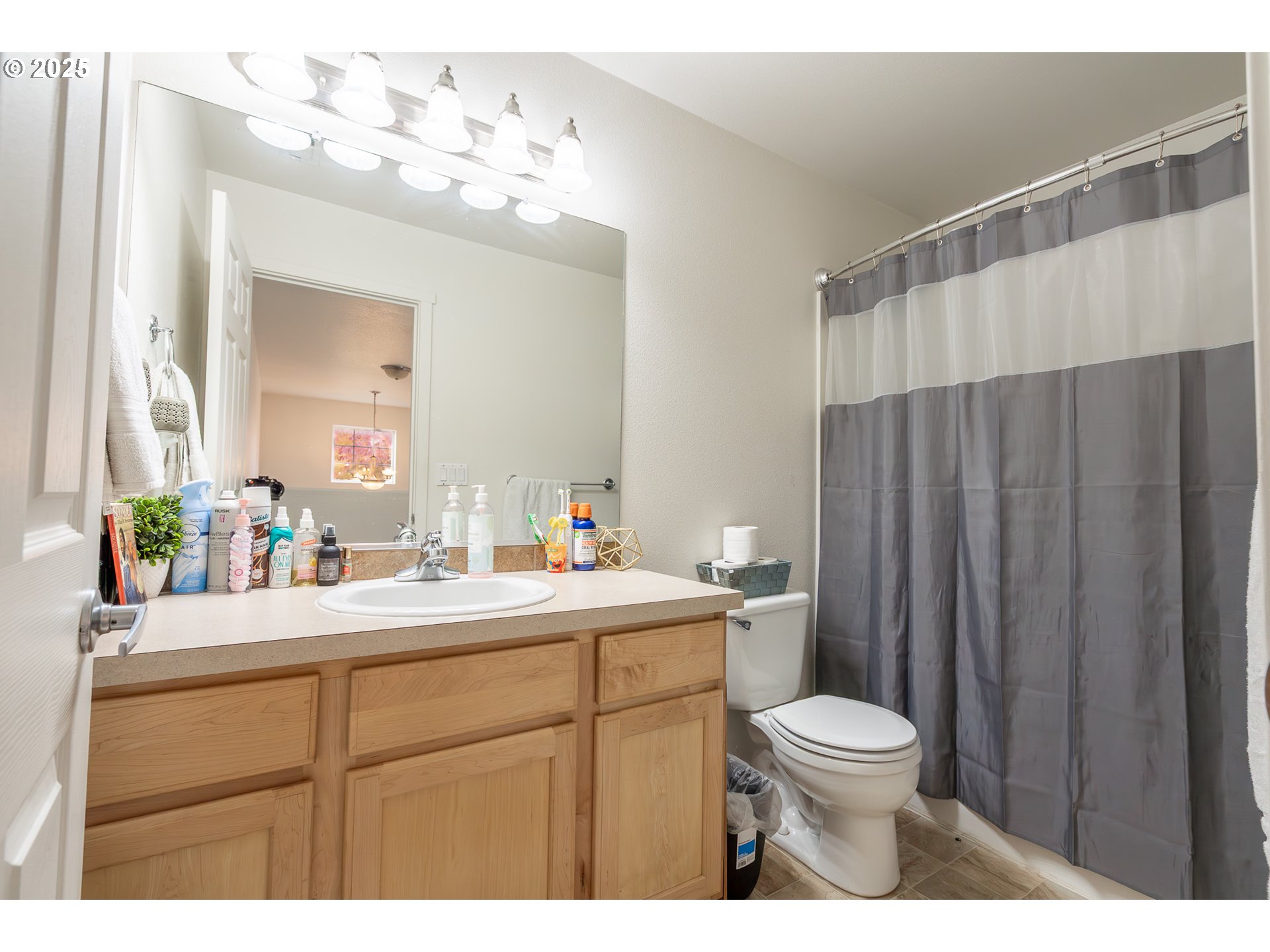 621 Jasmine Circle Independence, OR 97351 - Photo 23 of 29 a bathroom with a toilet a sink a mirror a vanity and shower