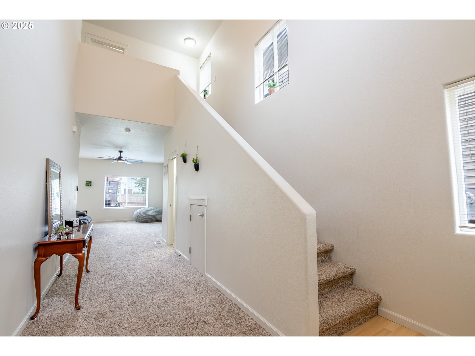 621 Jasmine Circle Independence, OR 97351 - Photo 3 of 29 a hallway with a couches and chandelier