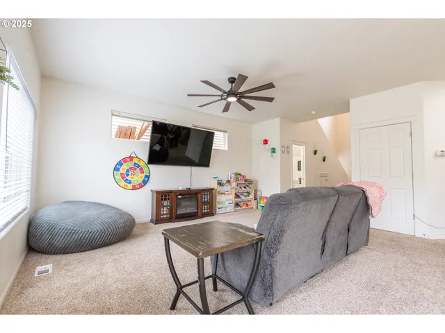 a living room with stainless steel appliances kitchen island granite countertop furniture and a kitchen view