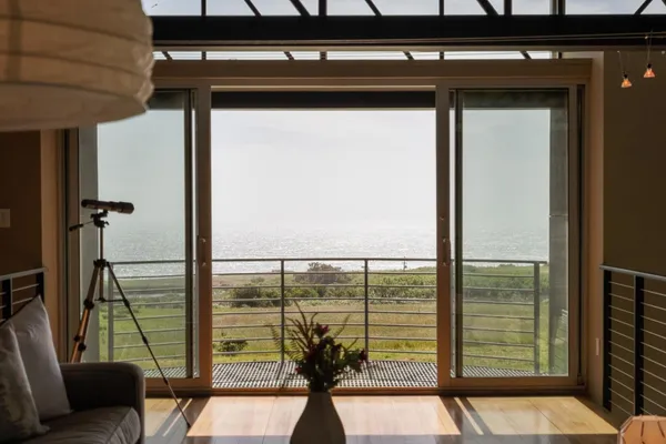 a living room with furniture and large windows