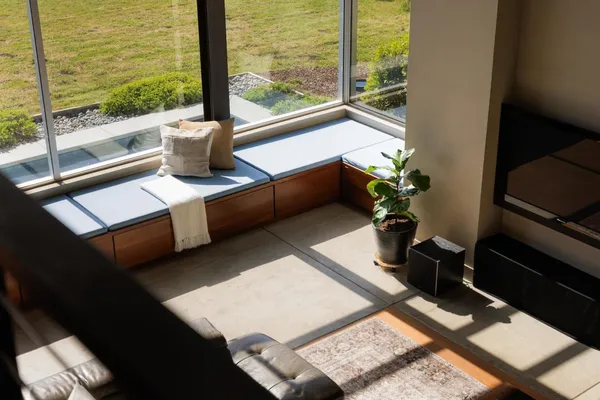 a living room with lots of furniture and a large window