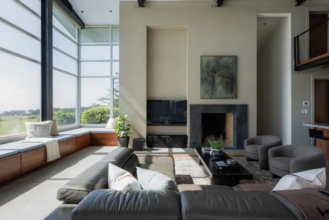 a living room with lots of furniture and a large window