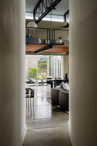 a bedroom with a bed and large window with balcony view