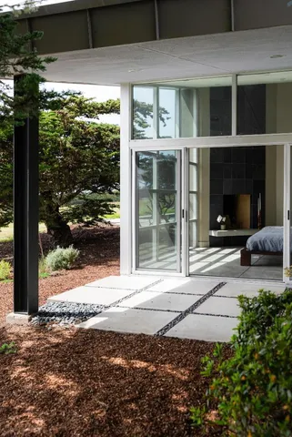 a view of a house with backyard and sitting area