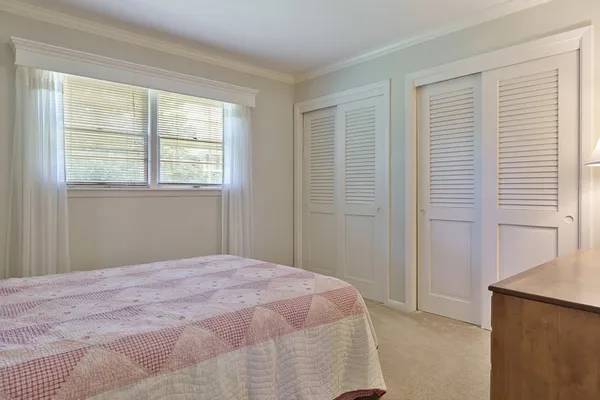 a view of an empty room with cabinet and a window