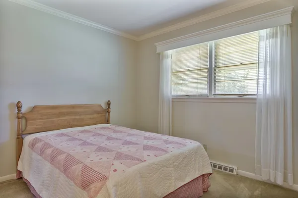a view of a cabinet and mirror in a room