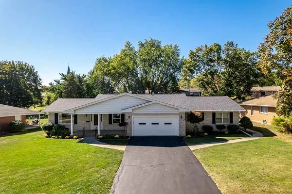 a front view of a house with a garden