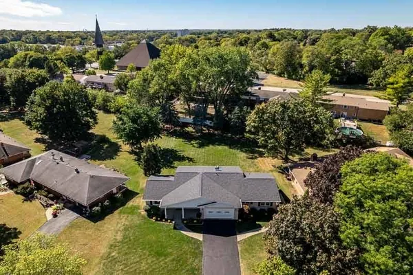 an aerial view of a house with a yard