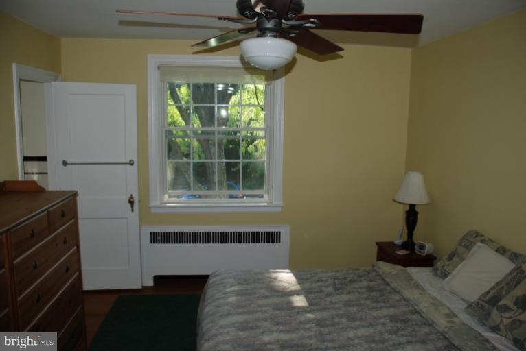 3711 Delverne Road Baltimore, MD 21218 - Photo 2 of 20 a bedroom with a bed and a chandelier