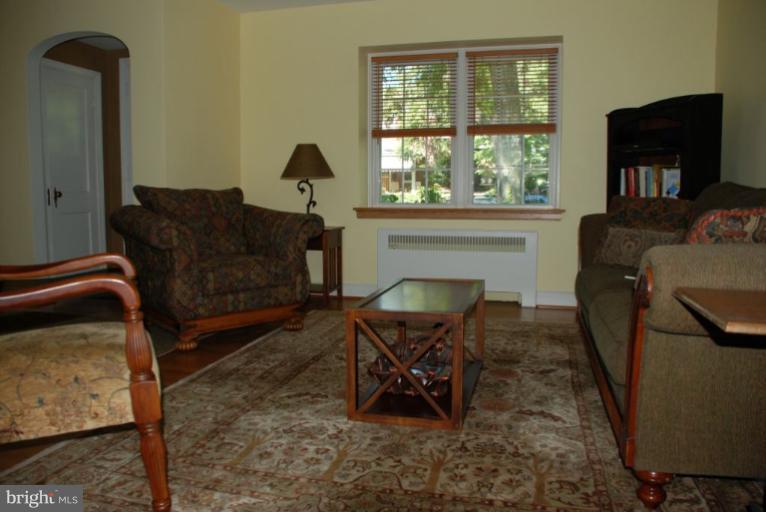 3711 Delverne Road Baltimore, MD 21218 - Photo 12 of 20 a living room with furniture and a fireplace