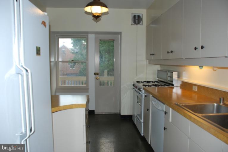 3711 Delverne Road Baltimore, MD 21218 - Photo 13 of 20 a kitchen with stainless steel appliances granite countertop a sink and a refrigerator