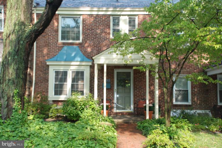 3711 Delverne Road Baltimore, MD 21218 - Photo 20 of 20 front view of a brick house with a large window and a yard