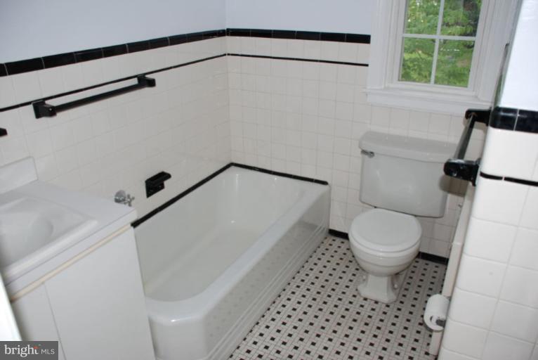 3711 Delverne Road Baltimore, MD 21218 - Photo 3 of 20 a bathroom with a toilet and a shower