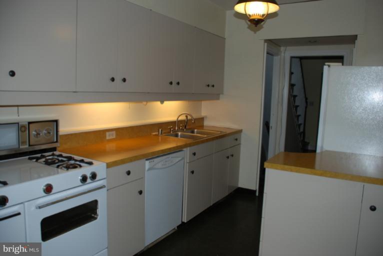 3711 Delverne Road Baltimore, MD 21218 - Photo 8 of 20 a kitchen with stainless steel appliances a stove a sink and a refrigerator