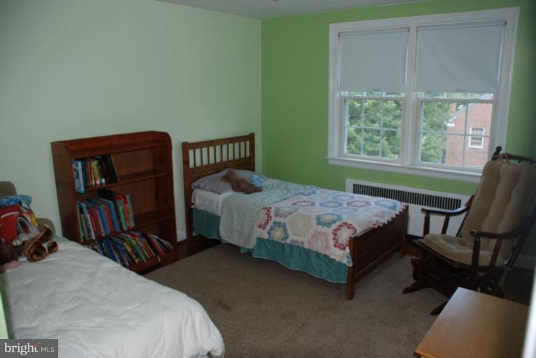 3711 Delverne Road Baltimore, MD 21218 - Photo 9 of 20 a bedroom with a bed chair and two windows