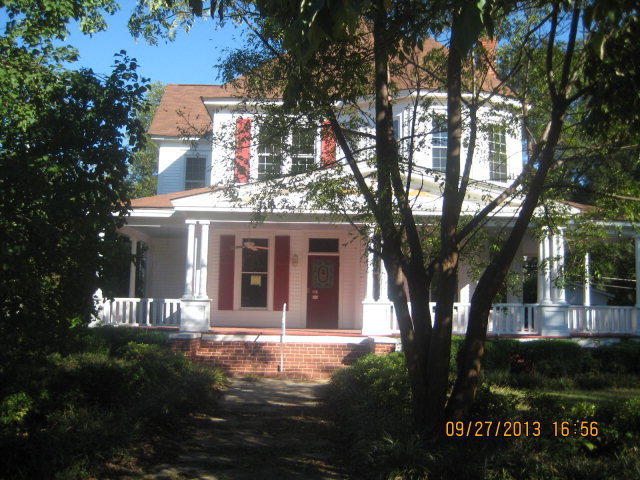 318 North Dooly Street Montezuma, GA 31063 - Photo 1 of 1 a front view of a house with yard and green space