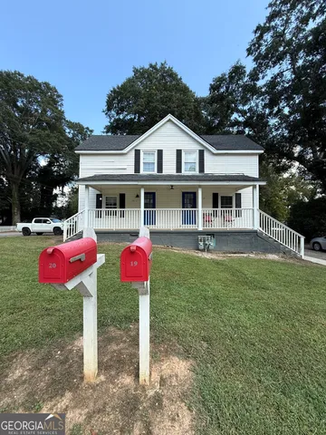 a front view of house with yard and trees