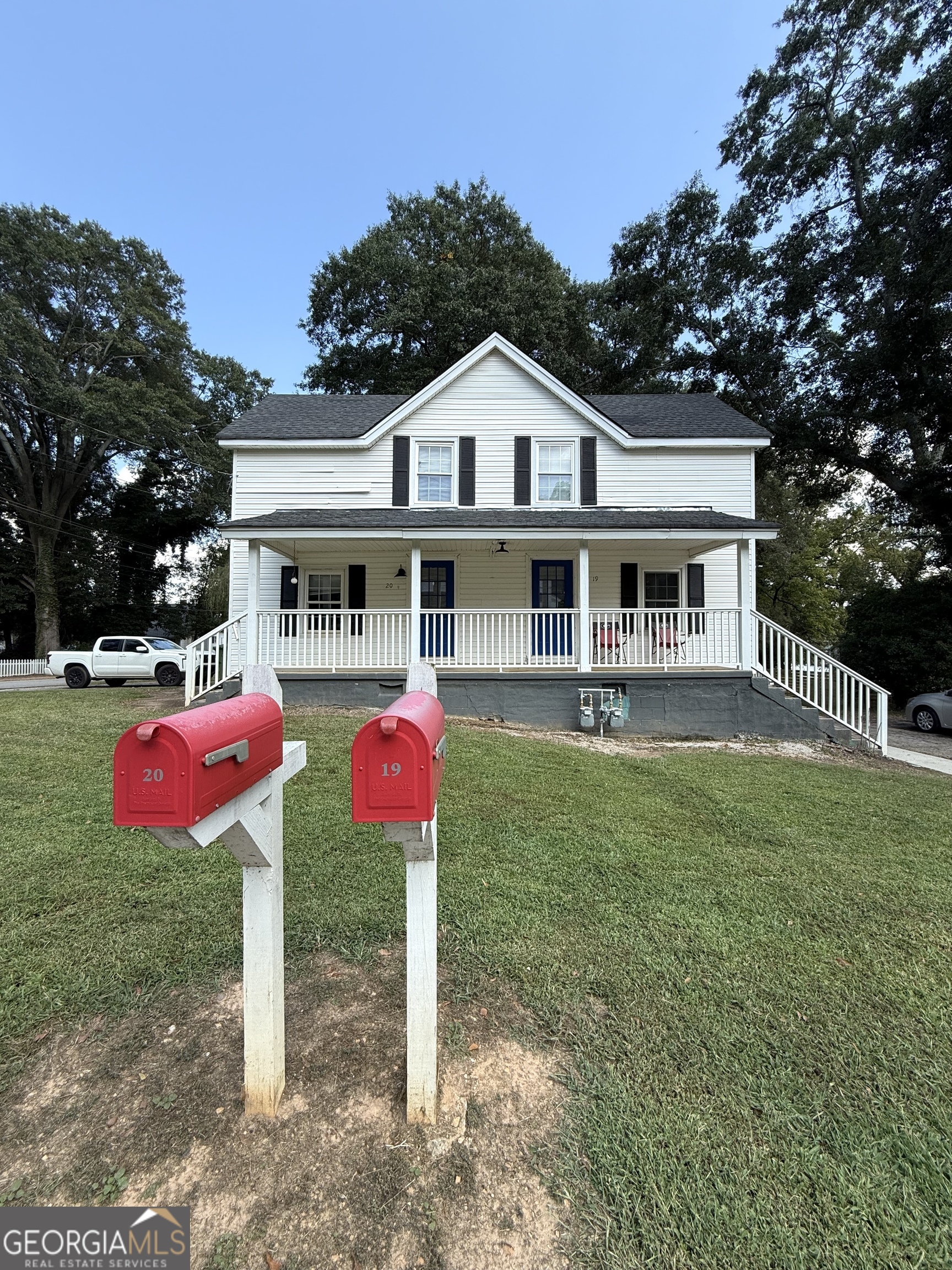 a front view of house with yard and trees