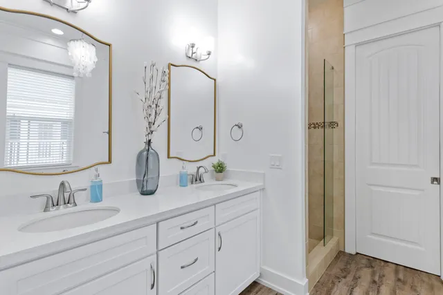 a bathroom with double vanity sinks and a mirror