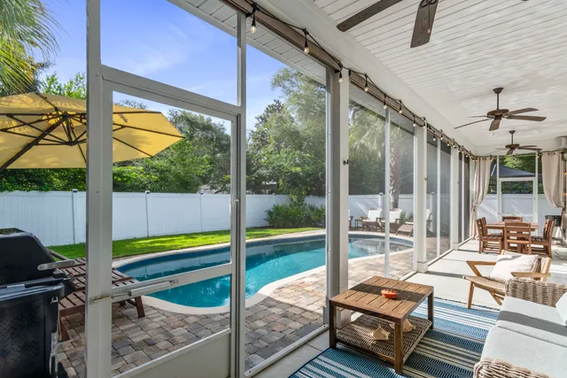 a bedroom with furniture and a large window