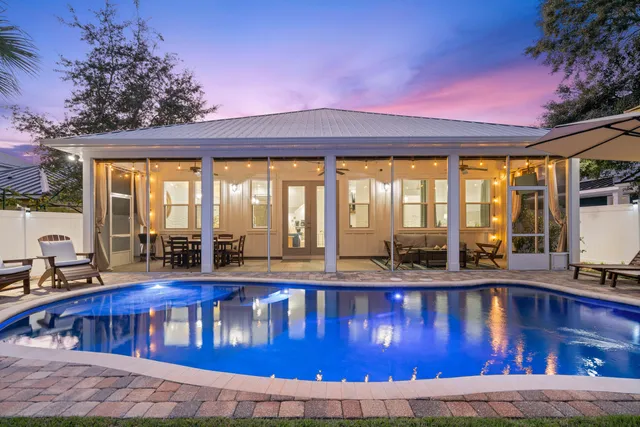 a view of a swimming pool with outdoor seating