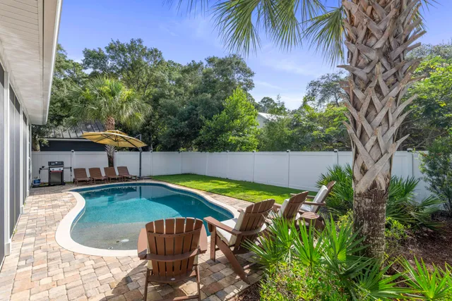 a swimming pool with outdoor seating and yard