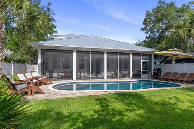 a view of a house with a yard and sitting area