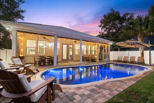 a view of swimming pool with outdoor seating and a yard