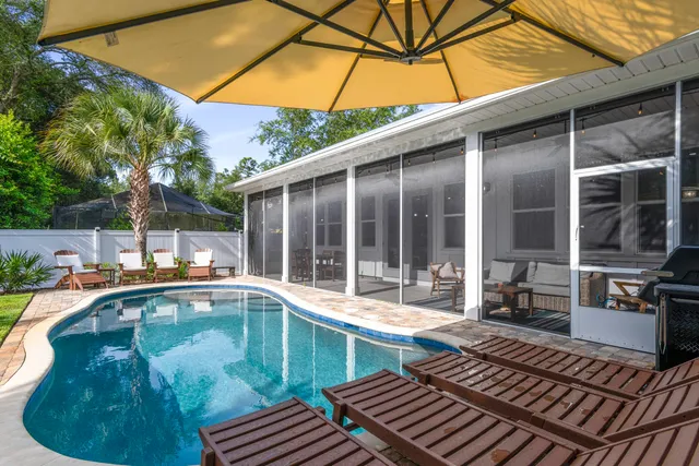 a swimming pool with outdoor seating and yard