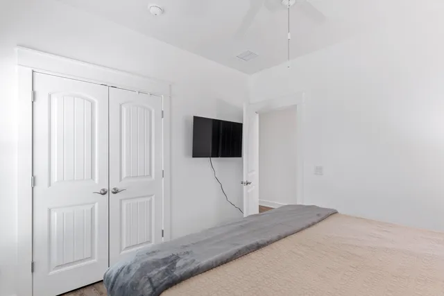 a bedroom with a bed and a flat screen tv