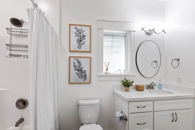 a bathroom with a toilet sink and a mirror