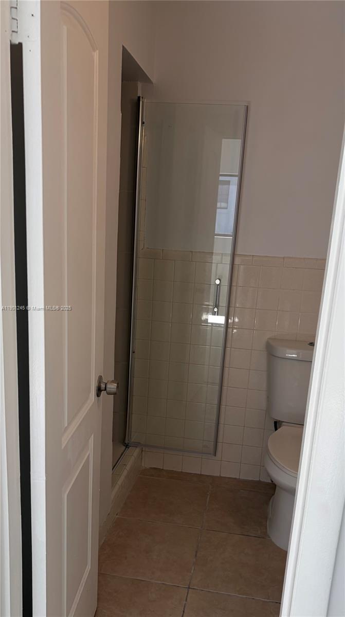 220 Southwest 7th Street, Unit 8 Boca Raton, FL 33432 - Photo 12 of 13 an empty room with an entrance to other room