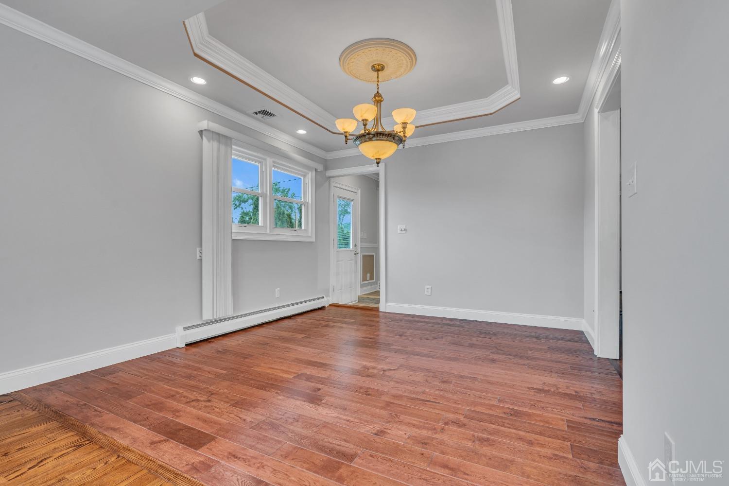 299 Fulton Street Middlesex, NJ 08846 - Photo 11 of 37 a view of an empty room with window and wooden floor