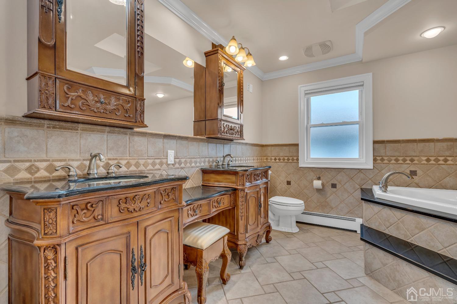 299 Fulton Street Middlesex, NJ 08846 - Photo 26 of 37 a spacious bathroom with a granite countertop double vanity sink a mirror and a toilet