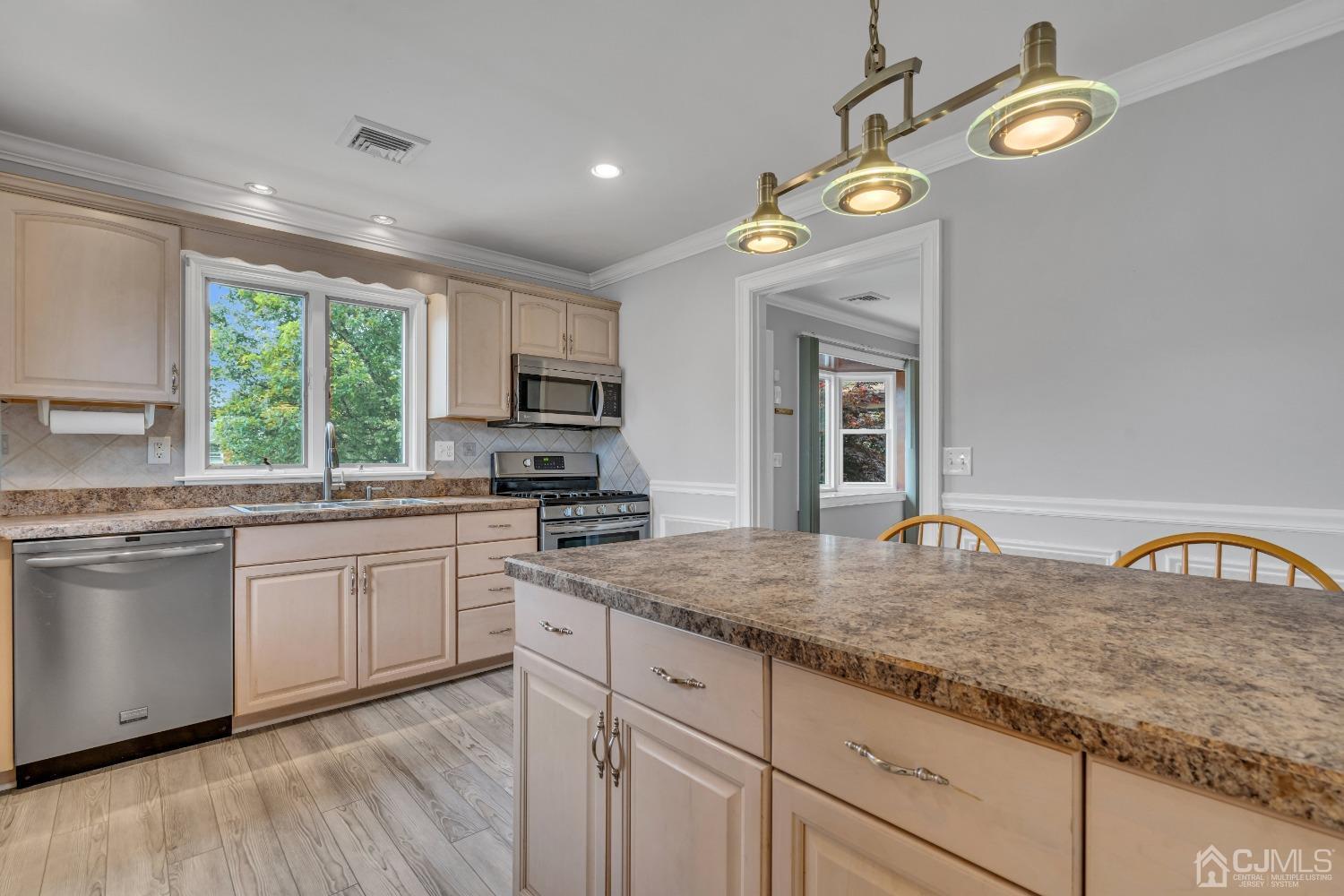 299 Fulton Street Middlesex, NJ 08846 - Photo 7 of 37 a kitchen with cabinets a window and appliances