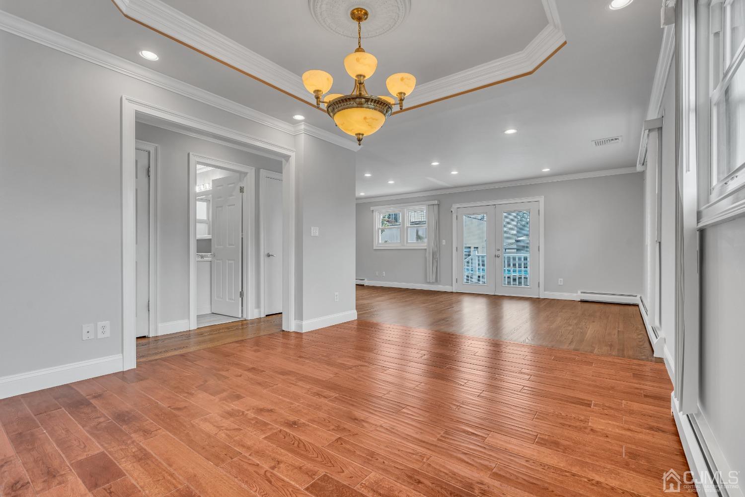 299 Fulton Street Middlesex, NJ 08846 - Photo 10 of 37 a view of an empty room with window and wooden floor